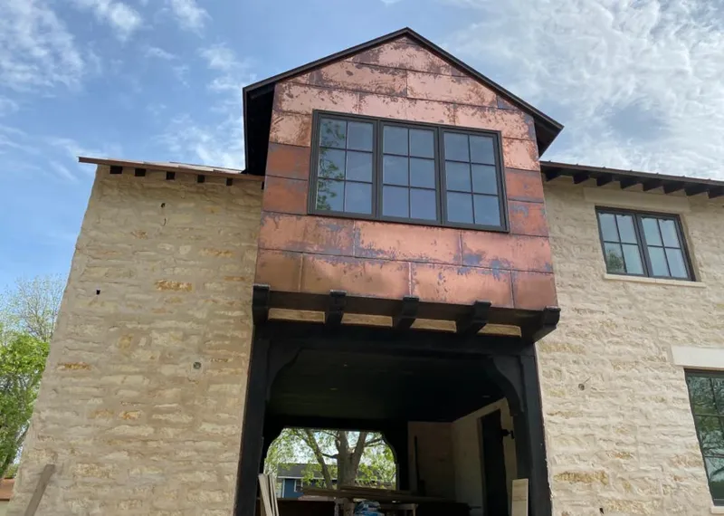 Copper metal panel facade on a stone building for Skylight Installation in Greenfield